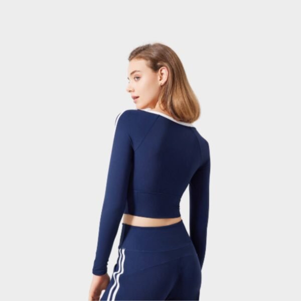 Back view of navy blue raglan crop top with contrast trim and sleek fit